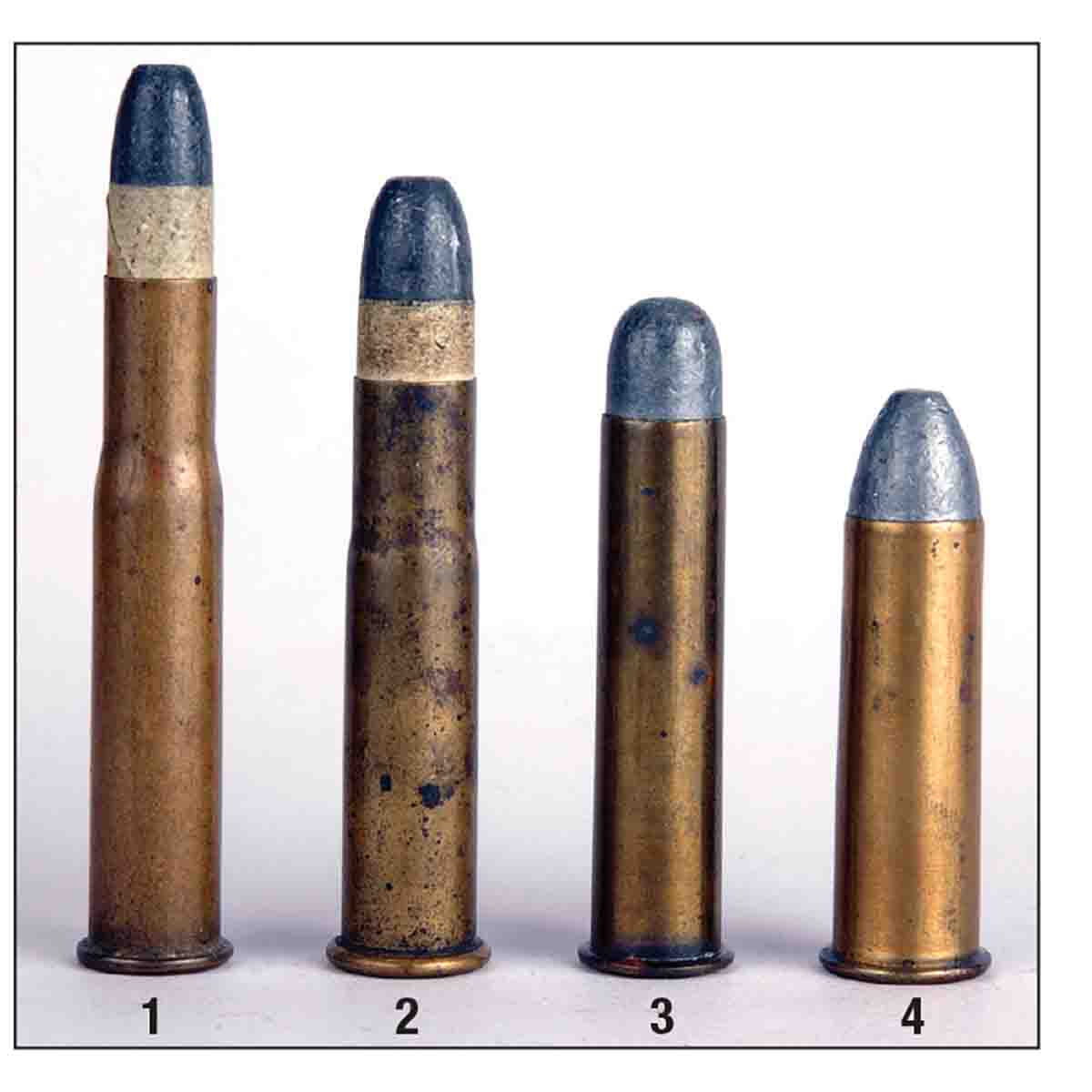 Shown here is a (1) .40-90 Sharps Bottleneck and a (2) .44-77 with some of its contemporary cartridges; a (3) .45 Government and a (4) .50 Government. All these cartridges are originals from the late 1800s.